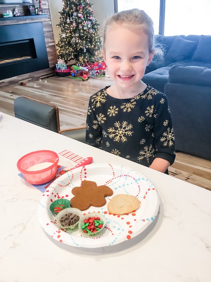 little girl sitting at counter for cookie decorating party