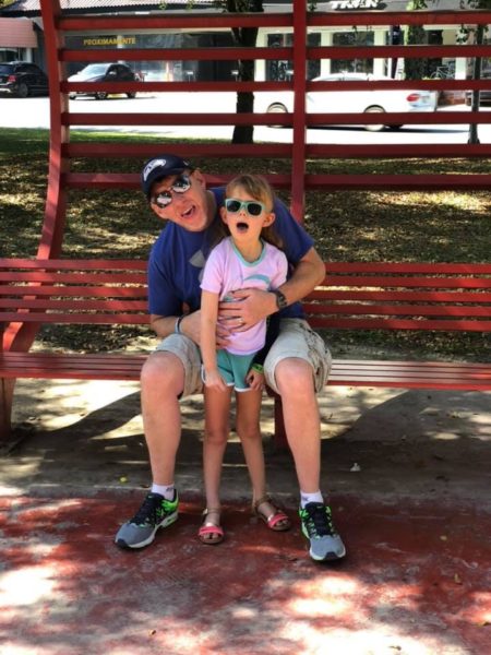 father and daughter sitting on bench