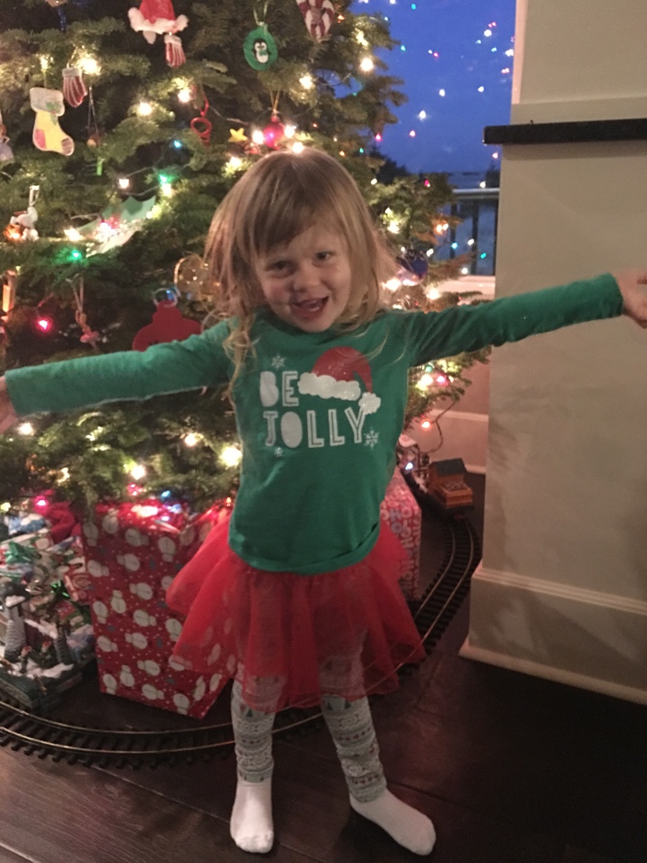 Little girl in front of Christmas tree