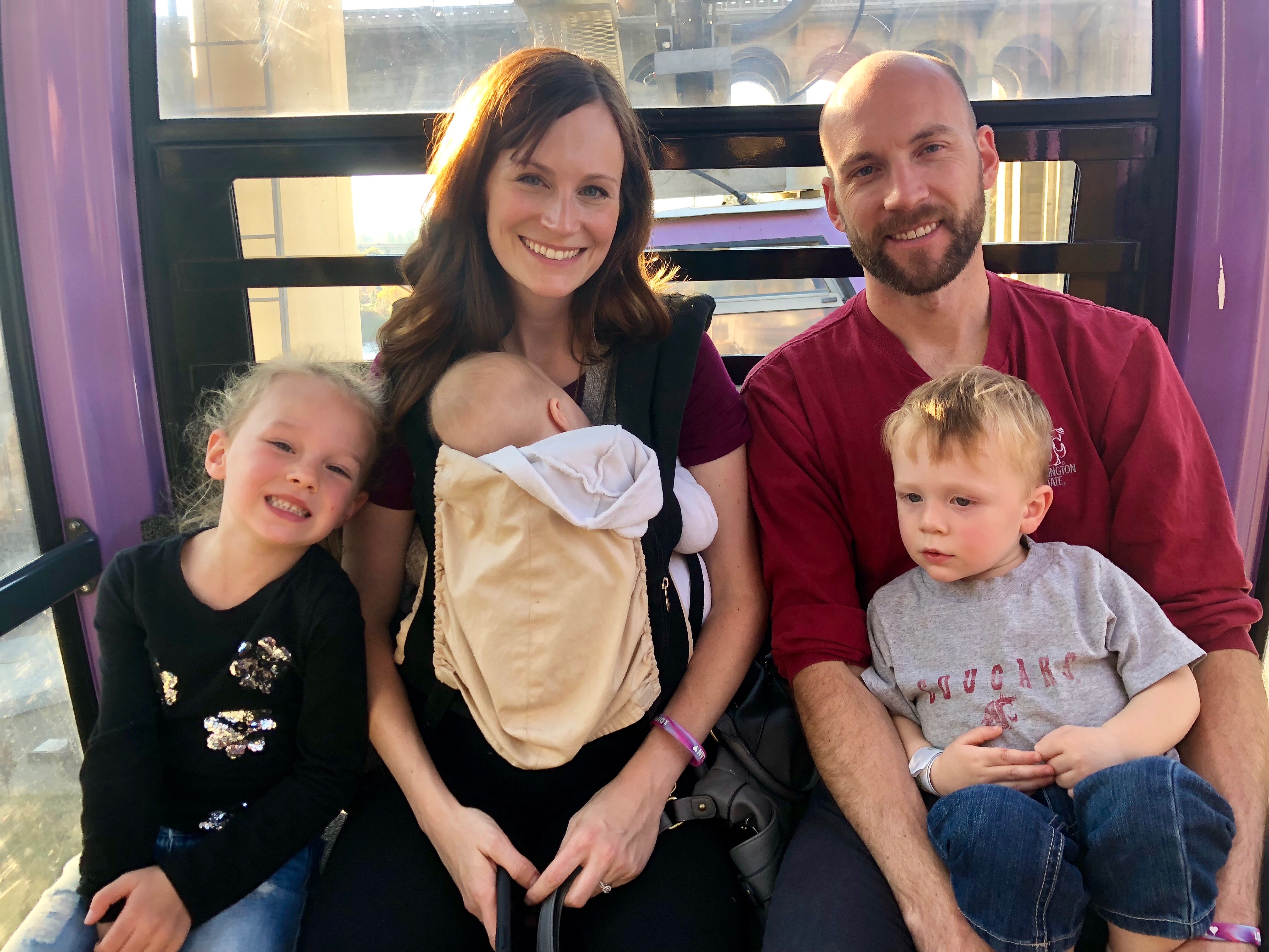 family of five with baby in carrier 