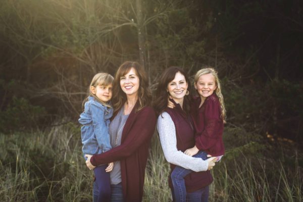 two sisters holding their daughters