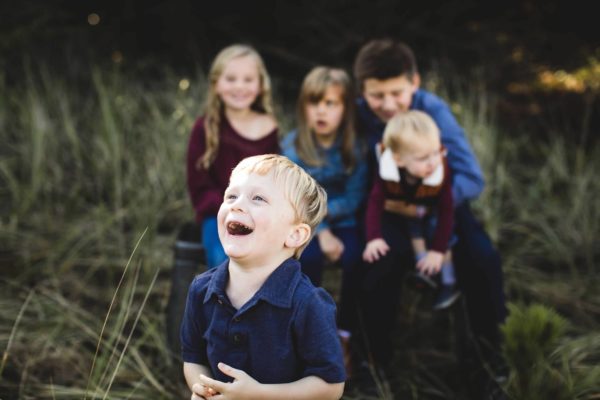 little boy laughing with cousins