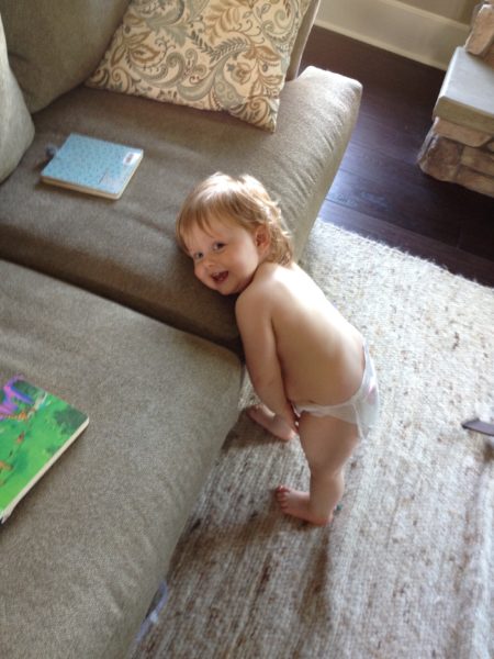 dylan in diaper leaning on couch