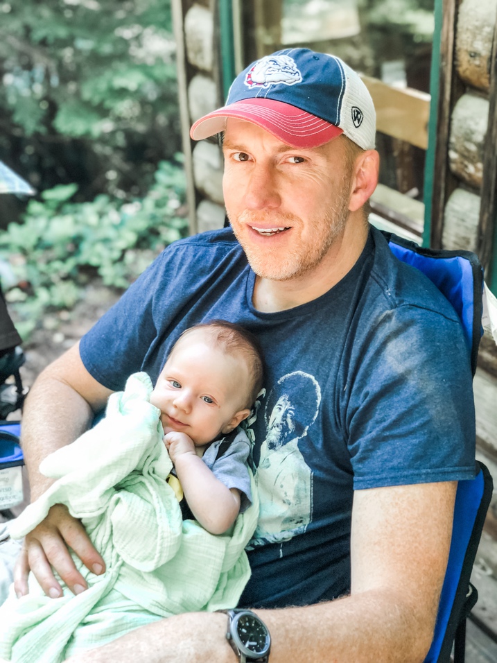 uncle jeff holds baby archer at cabin