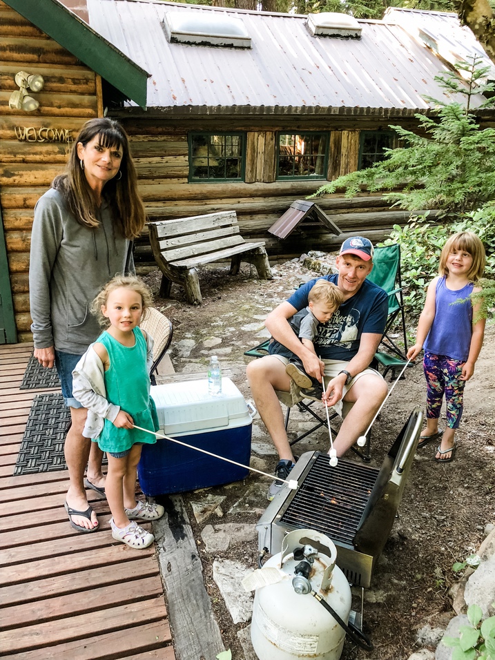 grandma, jeff, and kids roast s'mores at the cabin