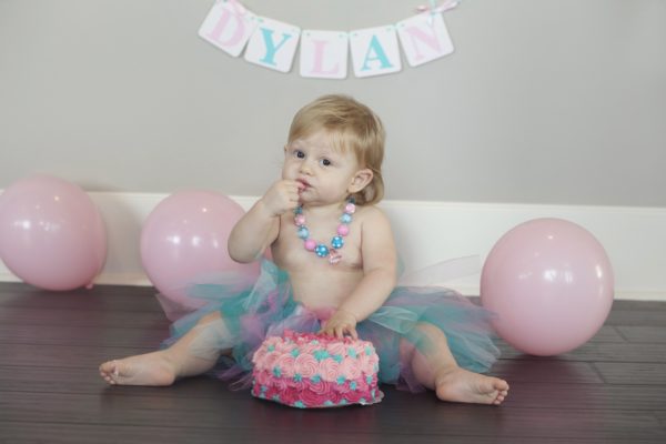 one year old girl eats cake