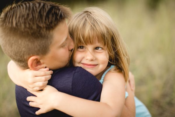 Mason holding Dylan while she hugs him